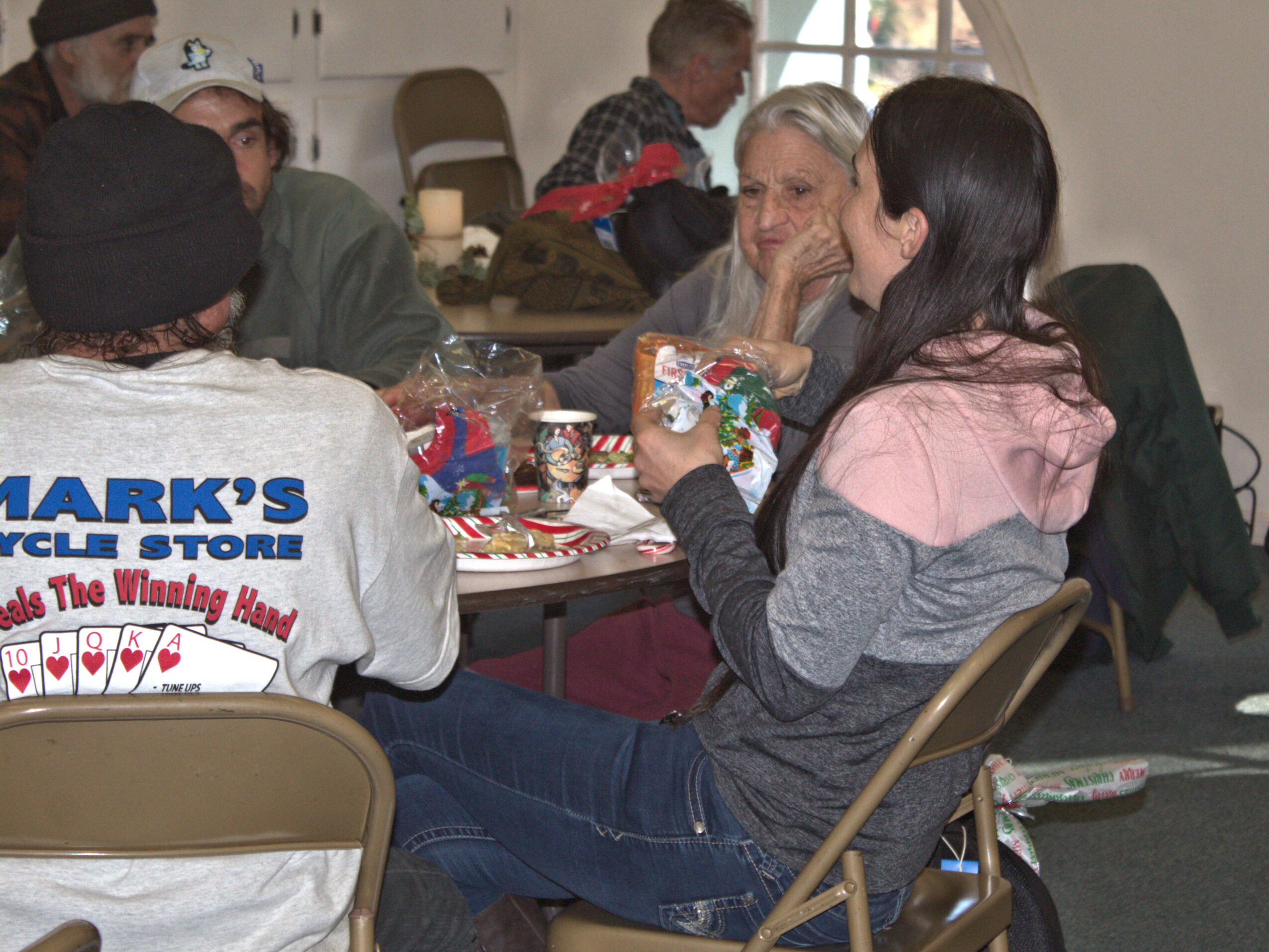 Community members gathered around a table during a Sierra Roots meal.