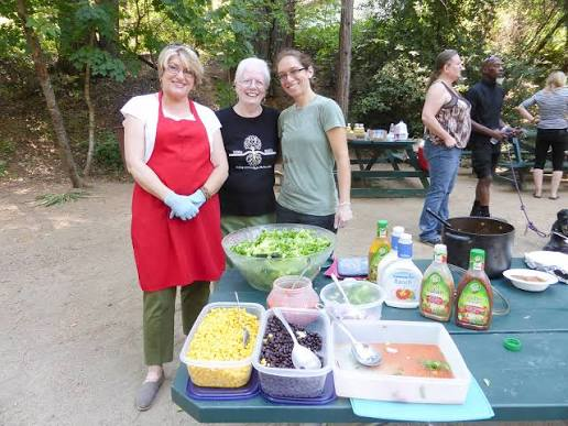 Sierra Roots volunteers preparing food for a community meal outdoors.